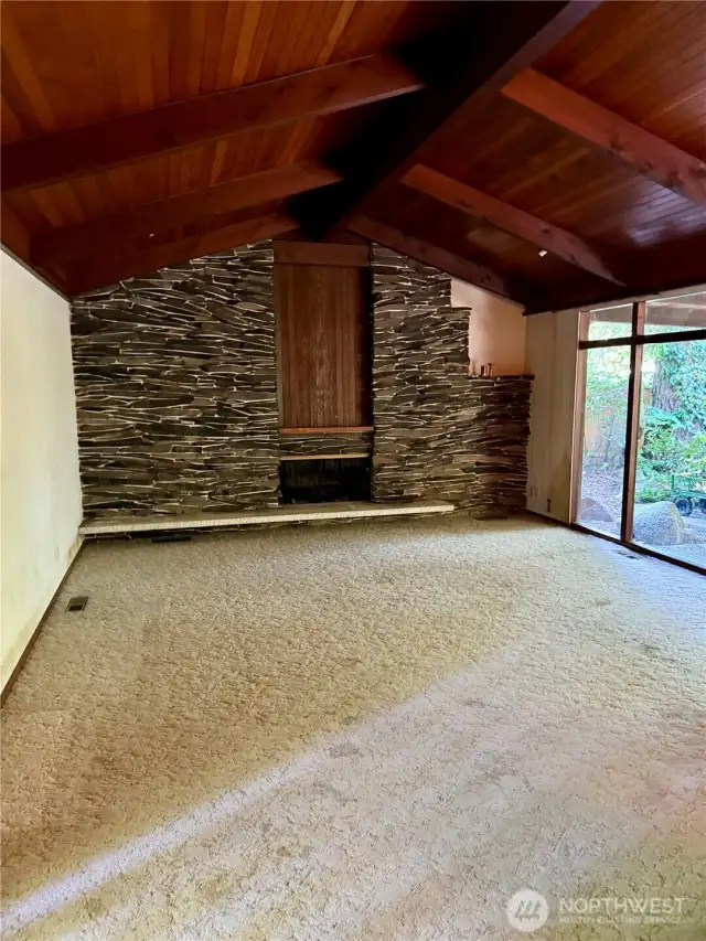 Living room with rock wall fireplace