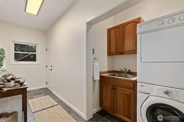 Main floor laundry/mud room/drop zone that leads out to the hot tub.