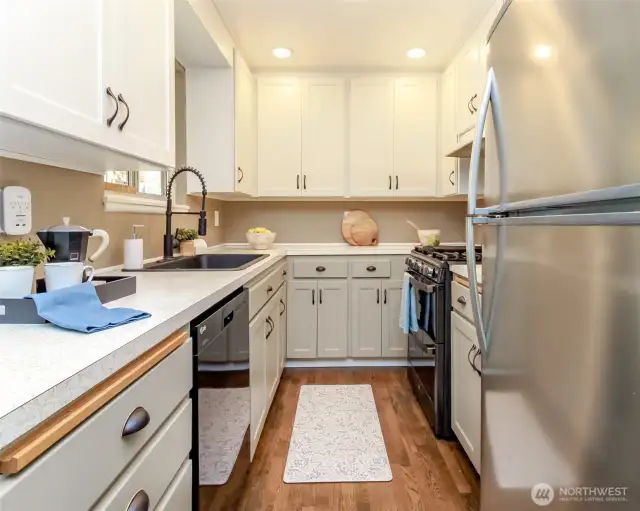 Partially updated kitchen with beautiful cabinets, updated appliances, sink, faucet and lighting.