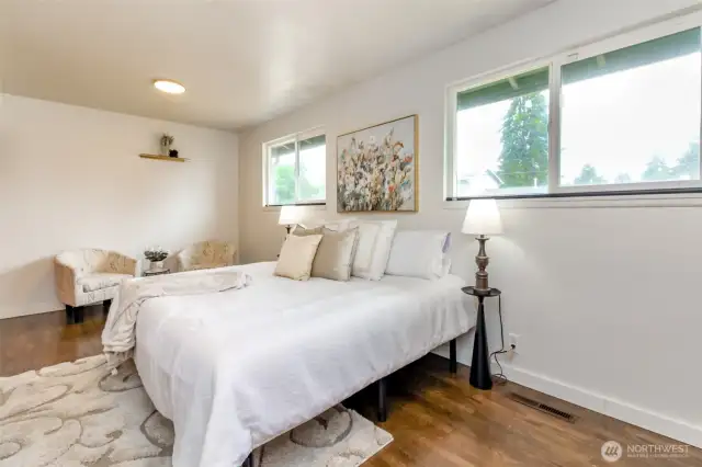 Primary bedroom with room for a sitting room and extra closet space.