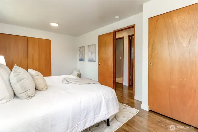 This angle from the primary bedroom is across from the second bedroom and the bathroom is the door to the left of the second bedroom.