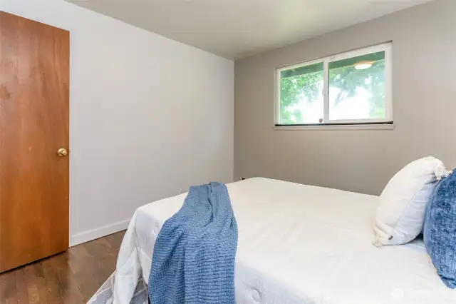 Second bedroom across from primary and the view is of the backyard.