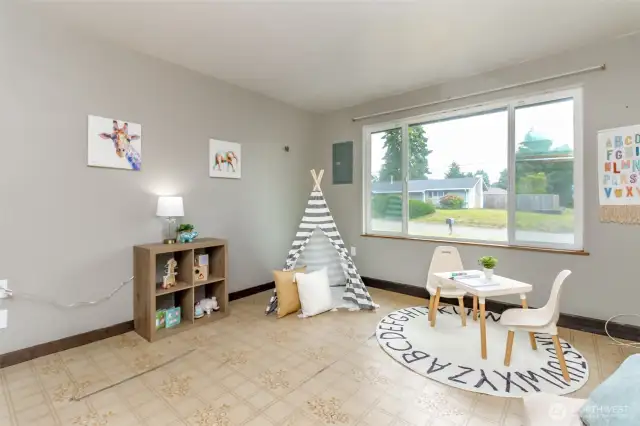 Third bedroom, vinyl floors and large picture window facing the street.