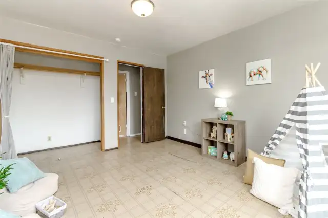 This view from the third bedroom faces the utility room straight across and the kitchen and rest of the house is to the right of this door. There is a single step up into the rest of the house.