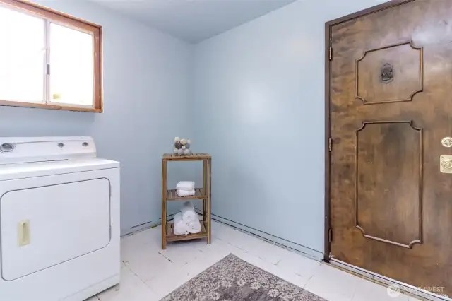 Utility room with a second backyard access door nearest to the detached garage.