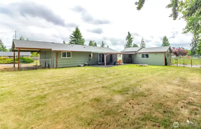 The fully fenced area behind the garage is the designated garden area.