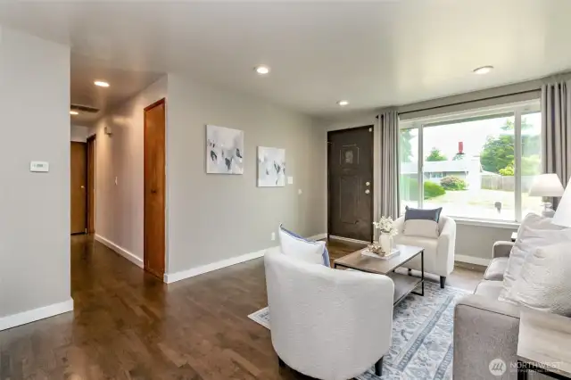 This picture was taken from the dining room area and shows the hallway leading to two of the three bedrooms and the full bathroom.