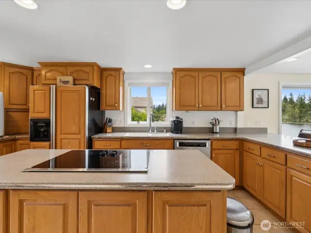 Gorgeous Kitchen w/ view, large Island, lots of counter space & storage galore with so many cabinets.