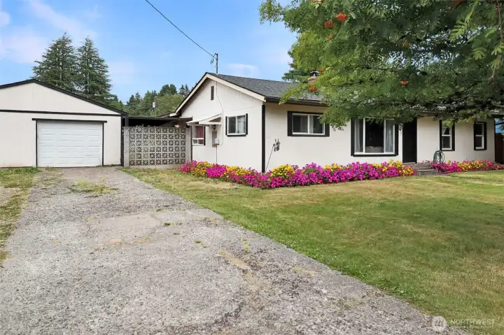 Large detached garage offers plenty of room for vehicles, storage, or a workshop.