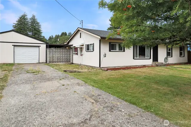 Large detached garage offers plenty of room for vehicles, storage, or a workshop.