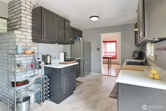 Bright kitchen space with fresh updates, thoughtful layout, and access to the outdoors.
