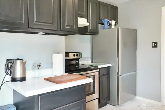 Smooth--top range bring both style and efficiency to this functional kitchen layout.