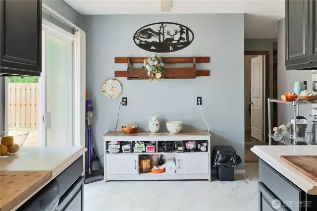 Light-filled breakfast nook connects the kitchen to the new deck—ideal for morning  coffee or casual meals.