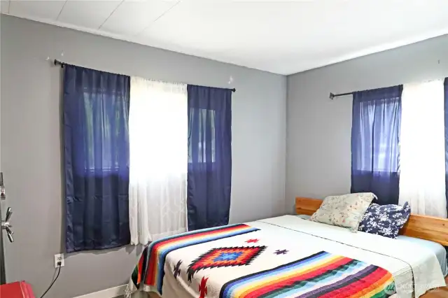 Light-filled bedroom with a peaceful feel and plenty of room to unwind.
