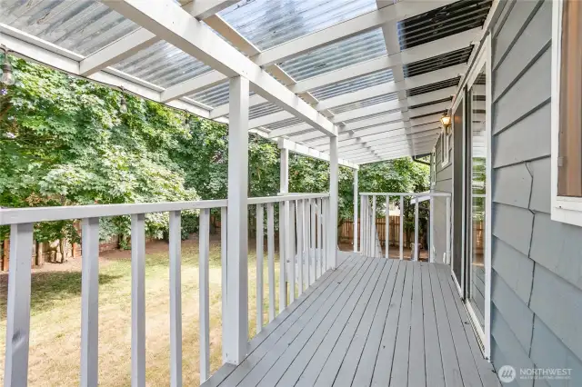 Stairs from upper deck lead to huge fenced in backyard