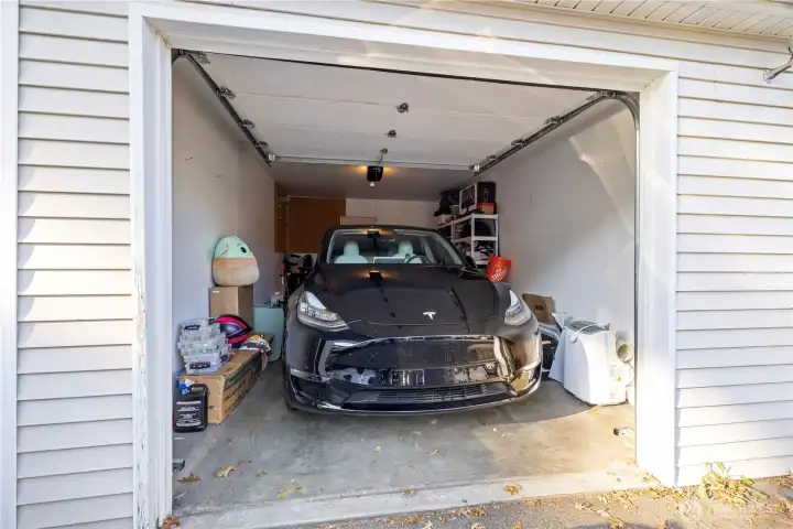 The garage is spacious enough to fit a full-size car while still providing room for extra storage. It can also accommodate future upgrades like an electric vehicle charging station.