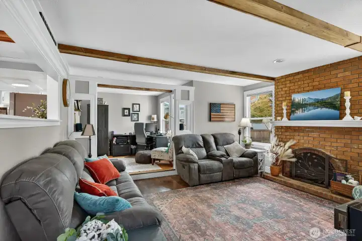 The living room is spacious and have a laminate style flooring.