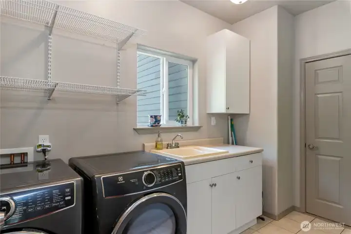 Large laundry room opens up to giant garage