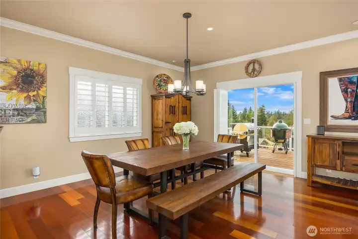 The dining area embraces beautiful water views and opens to the deck through sliding glass doors, creating the perfect setting for sunset dinners.