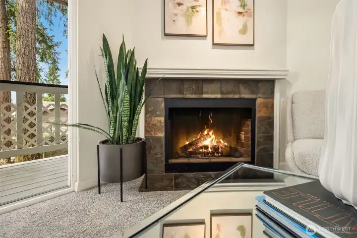 A classic wood-burning fireplace adds warmth and charm to the living space