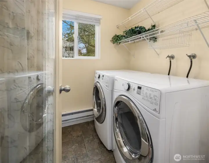 Utility room with generous storage that doubles as an overflow pantry, complete with full-size W/D.