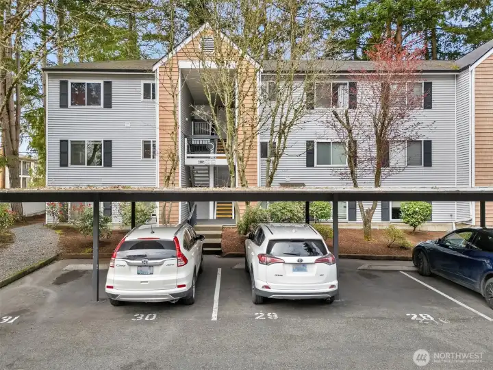 Exterior of Building B, with the second-floor corner condo situated at the far left