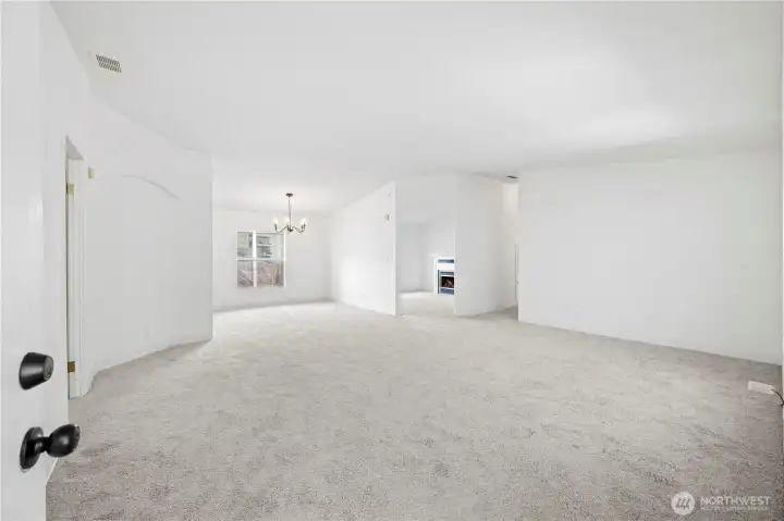 Come on in! Big living room is open to the dining room and den, too.