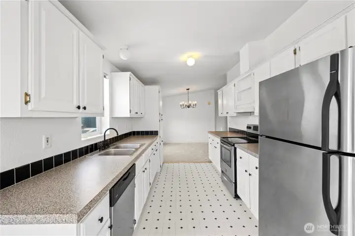Freshened up kitchen has stainless appliance and good counter workspaces.