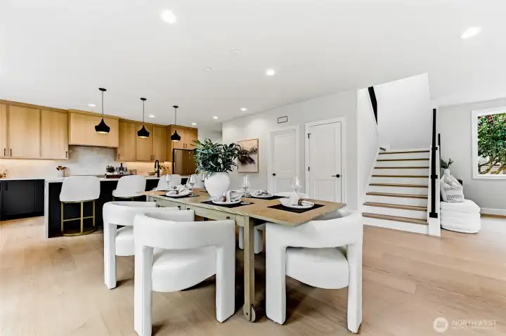 The dining room takes in glimpses of the generous kitchen area