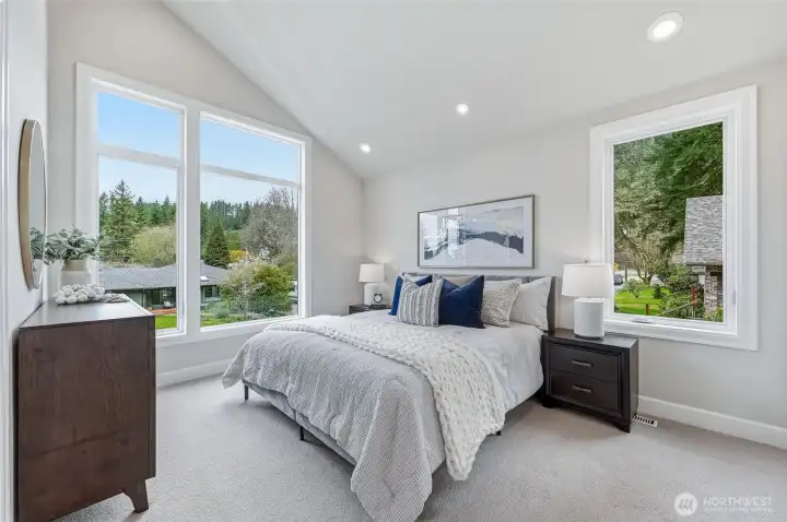 Sun drenched primary with vaulted ceilings for architectural interest