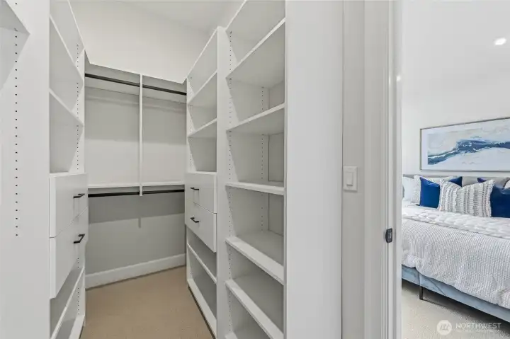 Primary closet with upscale built ins to make your closet life more organized.