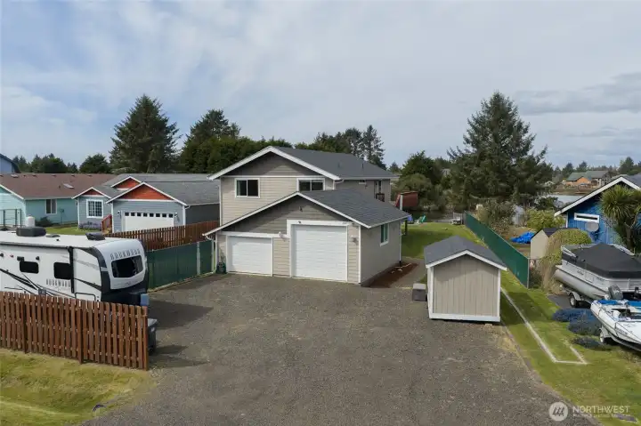 Large double garage and RV parking out front, along with a storage shed.