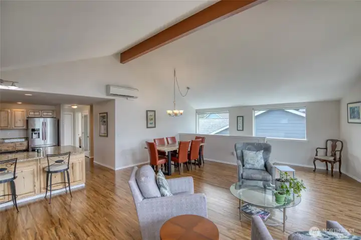 Down the hallway past the kitchen, the upper floor is rounded out by the main bath, one of two primary suites, and another bedroom.