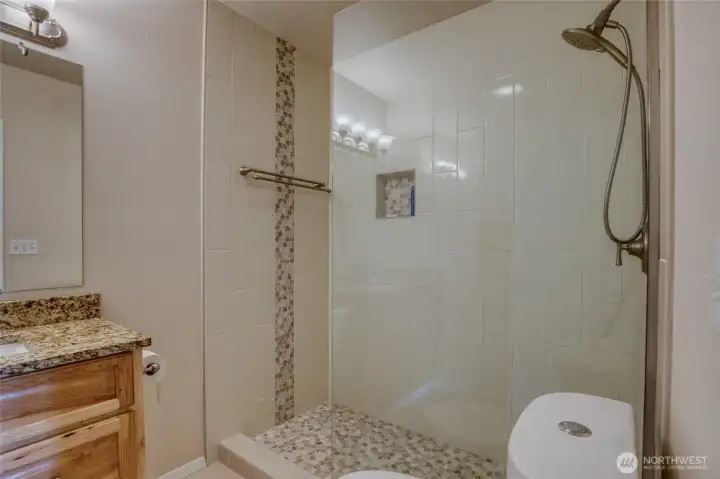 Ensuite bath features a luxurious walk in shower.