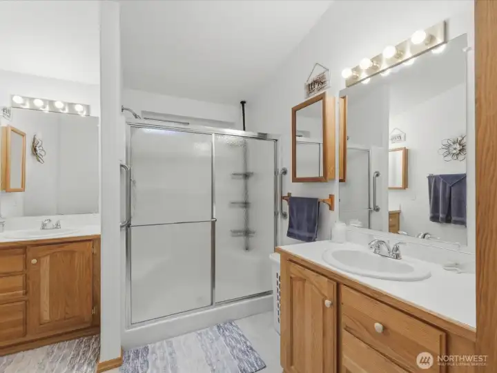 Primary bathroom with dual sinks and walk in shower