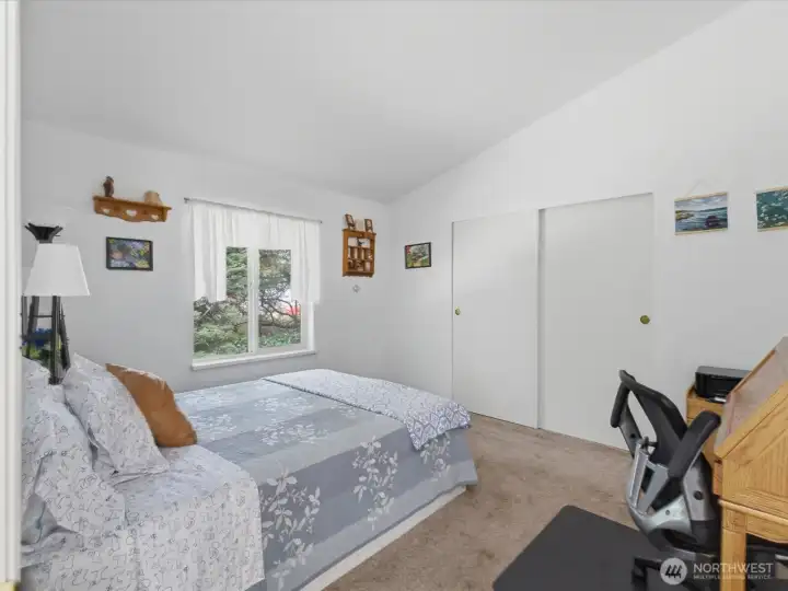 Large second bedroom with vaulted ceilings.