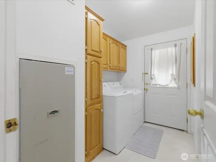 Utility room with tons of cabinets for extra storage.