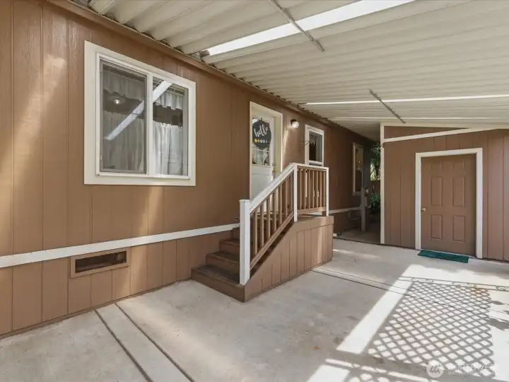 Carport is deep enough to park 2 cars. Access into the utility room, and door to the storage shed.