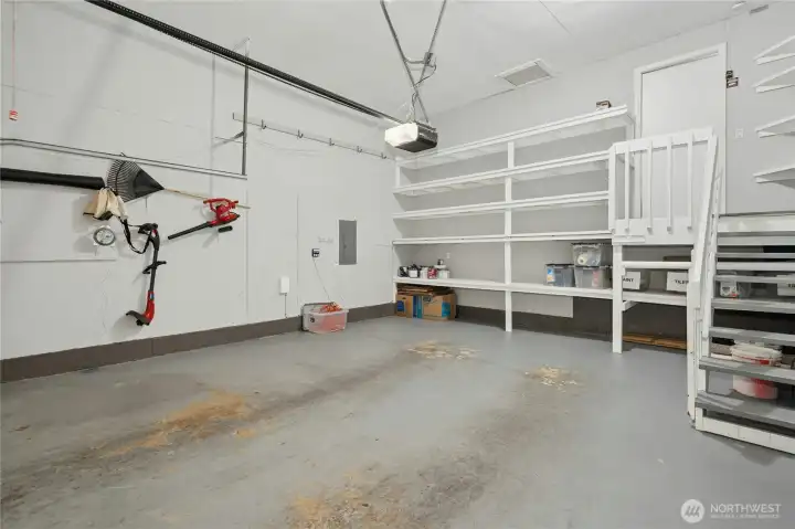 Spacious 2-car garage with built in shelves for lots of great storage