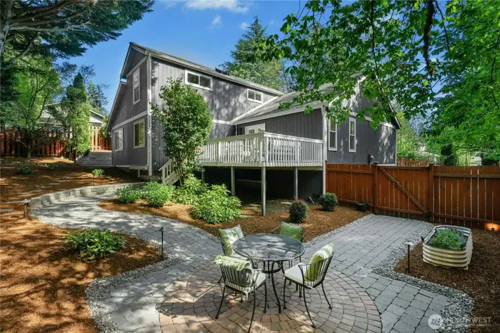 Meandering pathways and sun dappled spaces create an inviting outdoor retreat.