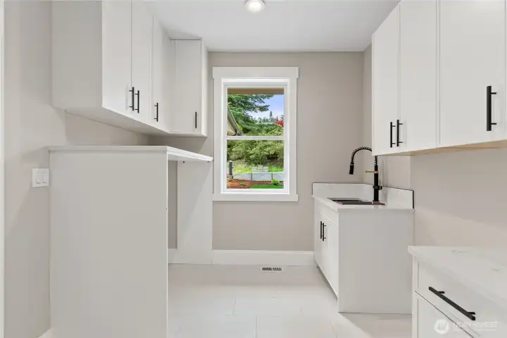 Large utility room with sink. Main floor.