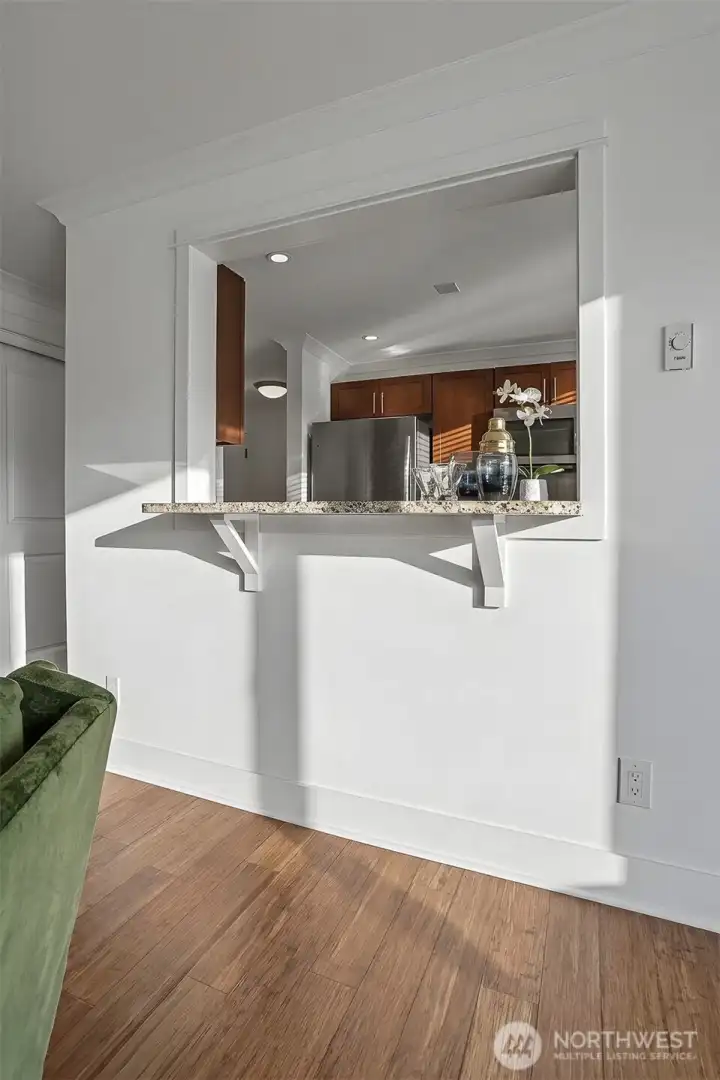 Open kitchen with a darling serving bar creates a warm and connected heart of the home. Open kitchen with a darling serving bar creates a warm and connected heart of the home.