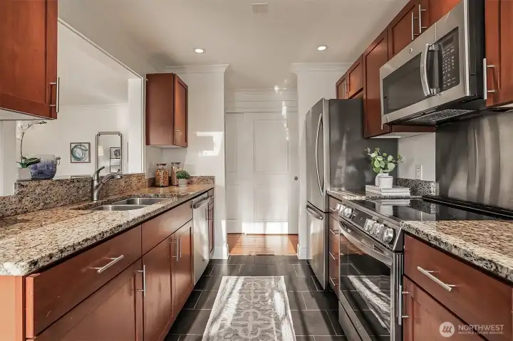 Beautiful, high end kitchen with slab granite countertops, cherry cabinets, stainless steel appliances and tile floors. Beautiful, high end kitchen with slab granite countertops, cherry cabinets, stainless steel appliances and tile floors.