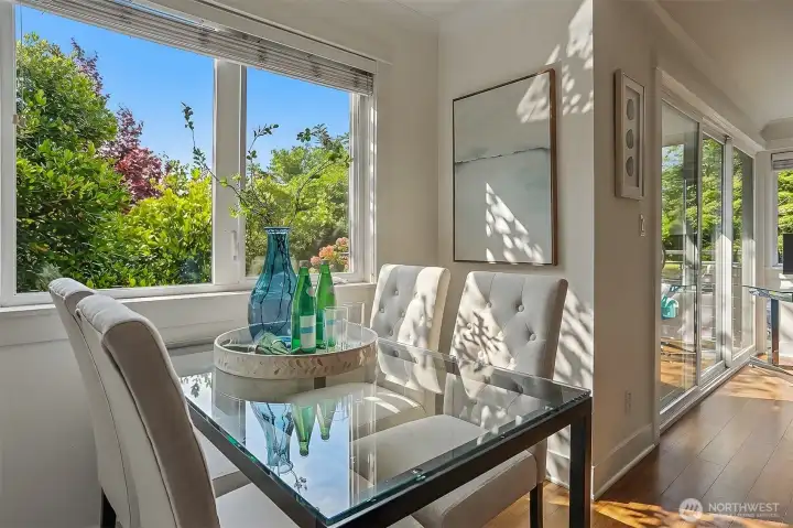 Sunlit dining room overlooking calming, tree-lined views. Sunlit dining room overlooking calming, tree-lined views.