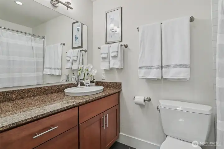 Primary suite bathroom with granite counters for a clean, elevated finish Primary suite bathroom with granite counters for a clean, elevated finish