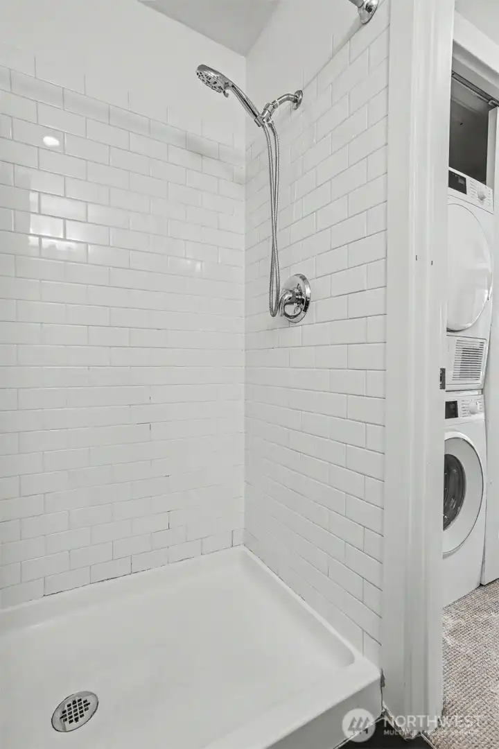Sleek walk-in shower wrapped in classic tile. Sleek walk-in shower wrapped in classic tile.