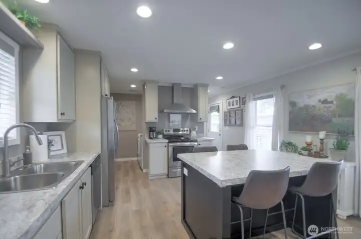 KITCHEN WITH ALL STAINLESS STEELE APPLIANCES AND KITCHEN ISLAND