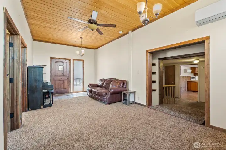 View of the front door. To the right is the hallway leading into the kitchen. View of the front door. To the right is the hallway leading into the kitchen.