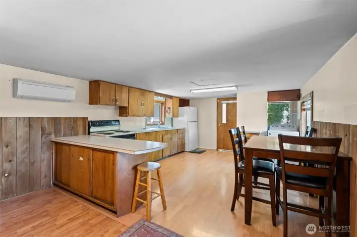 Kitchen and dining area. Notice the Mini-Split heat pump for comfortable temperatures year round. Kitchen and dining area. Notice the Mini-Split heat pump for comfortable temperatures year round.