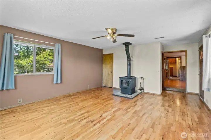Large family room with a wood stove and big windows. Large family room with a wood stove and big windows.